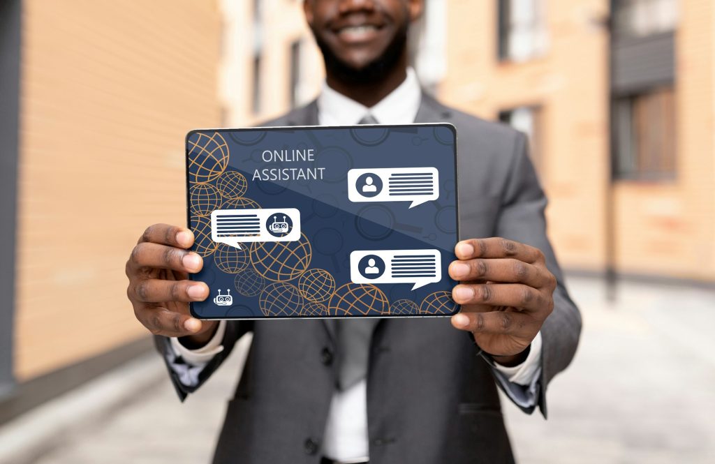 Black businessman showing digital tablet with online assistant app, cropped